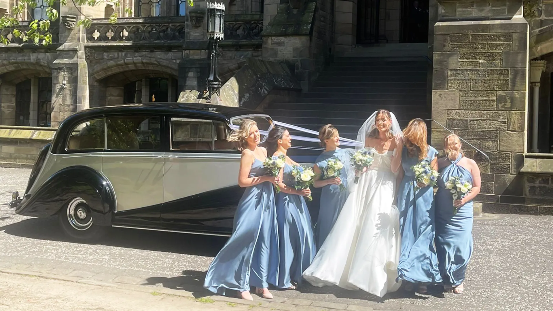 Classic Rolls-Royce limousine in front of Glasgow University Chapel with Bride and Bridesmaids